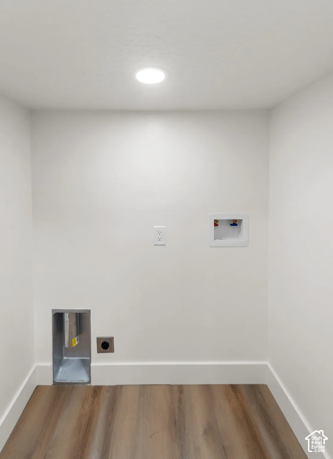 Wood-finish flooring, recessed lighting, and white walls with trim