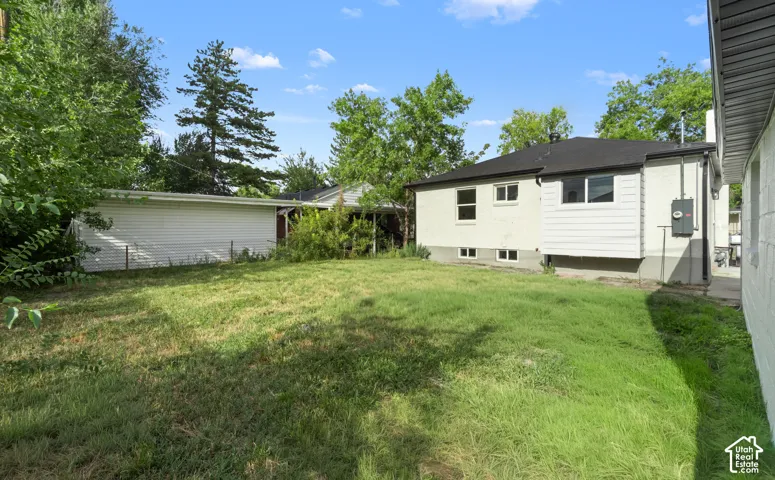Expansive grassy yard with mature trees
