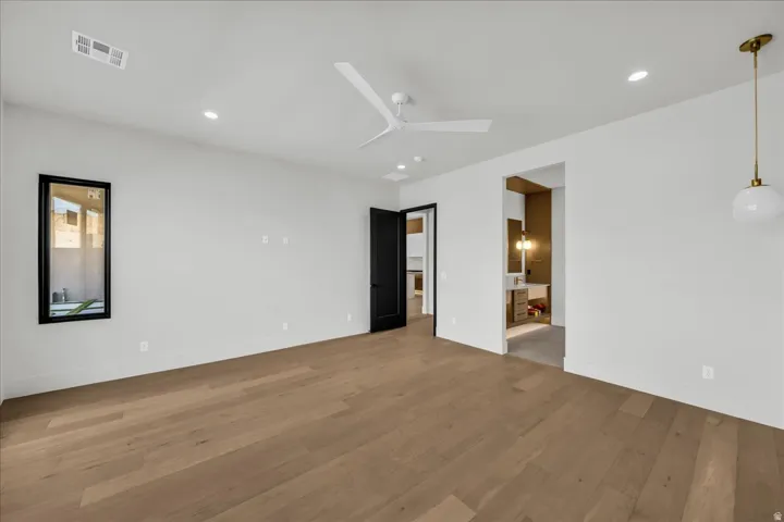 Wood-finish flooring throughout, recessed lighting, and a modern ceiling fan