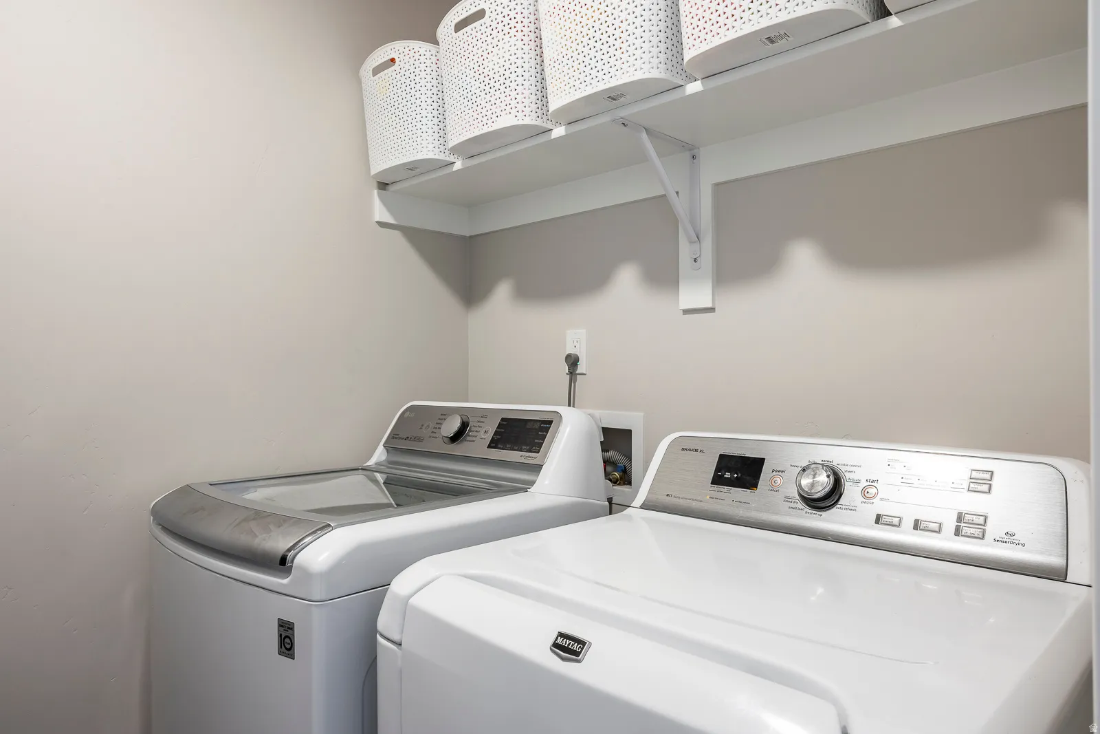 Dedicated laundry space with mounted shelving