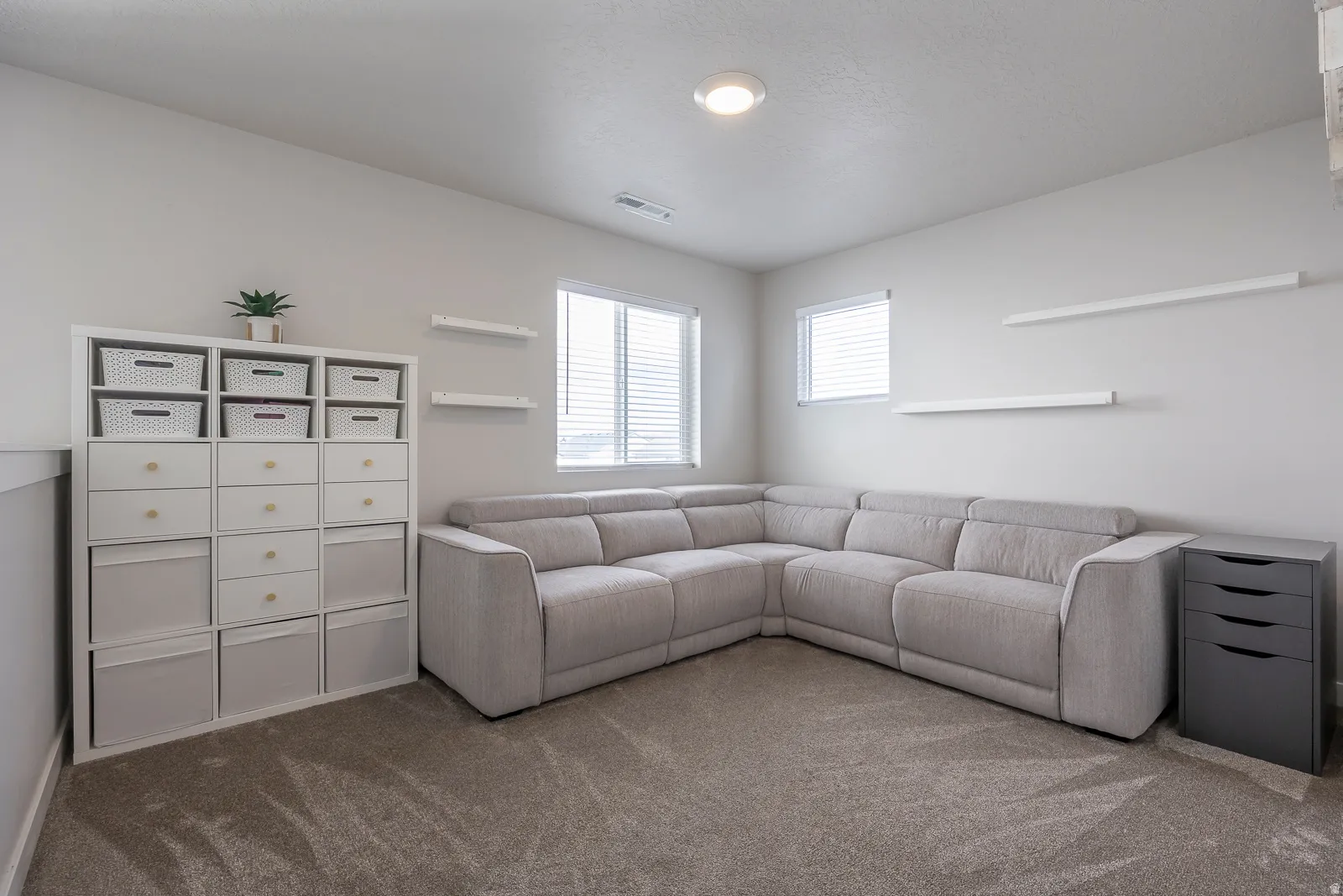 Carpeted room with recessed lighting and multiple windows featuring blinds
