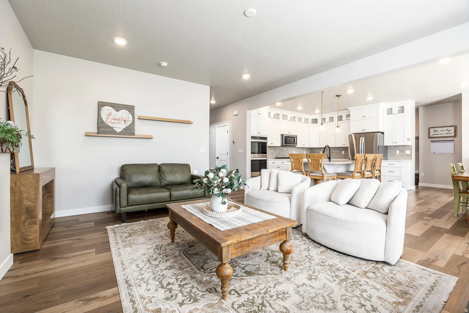 Wood-finish flooring, recessed lighting, and an open-concept layout
