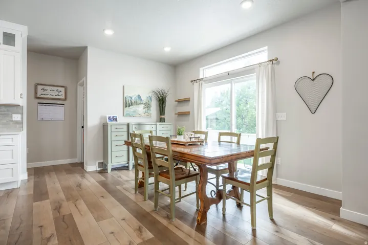 Wood-finish flooring throughout, complemented by recessed lighting and a sliding glass door