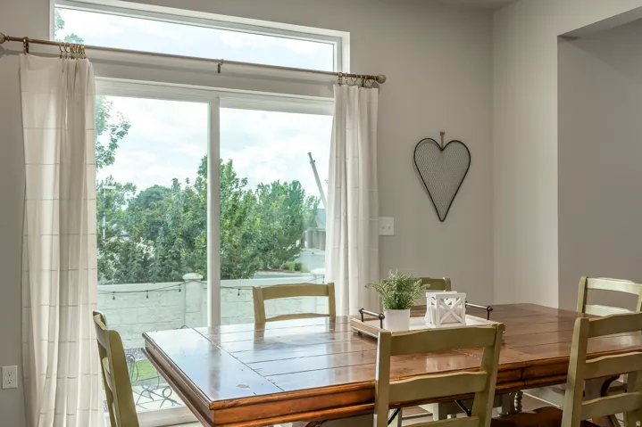 Sliding glass door, transom window, and neutral wall tones