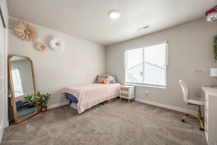 Wall-to-wall carpeting, window with horizontal blinds, built-in closet with sliding door, recessed lighting