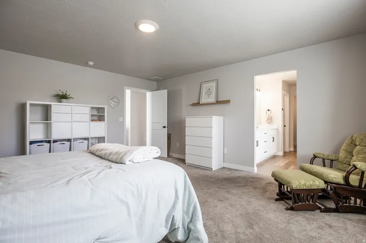 Recessed ceiling light, neutral wall paint, carpet flooring, entryway to bathroom, vanity with base cabinetry