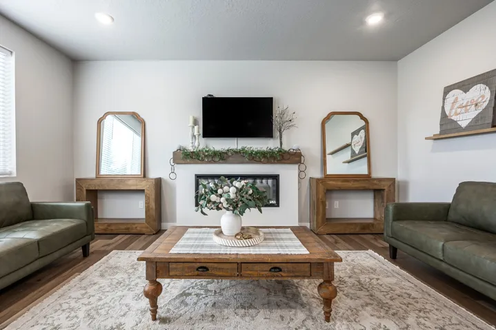 Recessed lighting, wood-finish flooring, a built-in fireplace, and a wood mantel