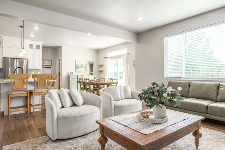 Open-concept living space featuring wood-finish flooring, recessed lighting, and a sliding glass door