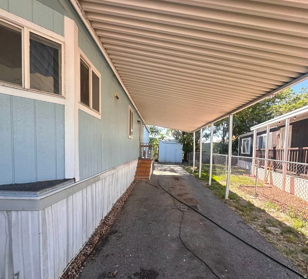 Covered carport with metal roof and support columns