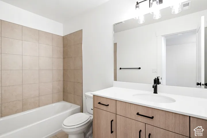 White bathtub with light-colored wall tiling