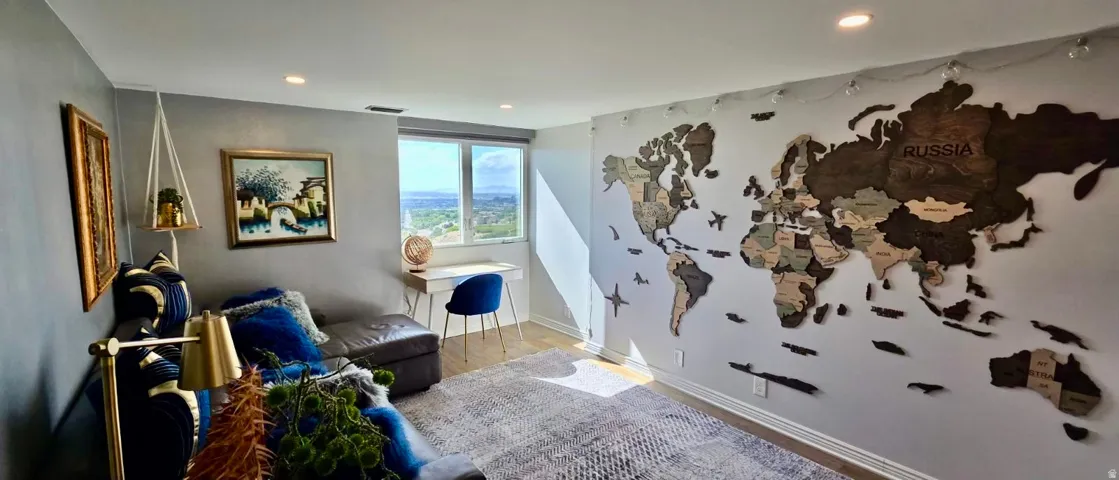 Recessed ceiling lighting, wood-finish flooring, and a large window