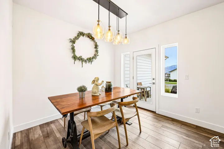 Dining with a door leading to a patio area.