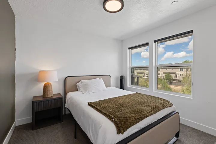 Bright room featuring two windows, recessed lighting, and carpeted flooring