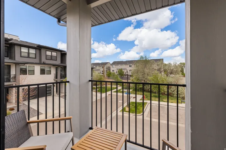 Private balcony featuring black metal railings and a grey slatted ceiling