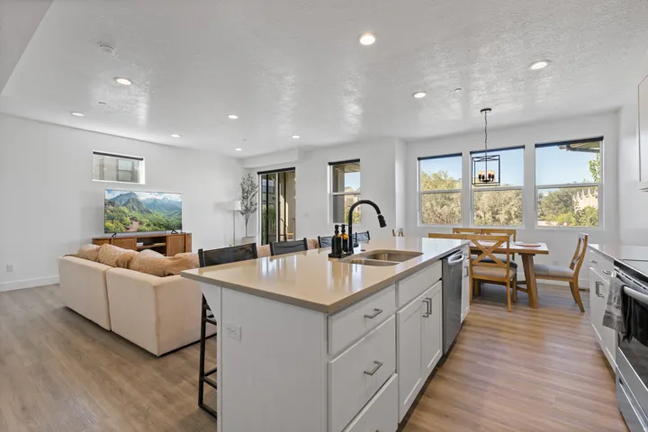 Kitchen island featuring a double-basin sink and a black gooseneck faucet