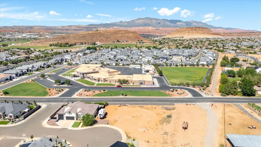 Expansive community with varied architectural styles set against a mountain backdrop