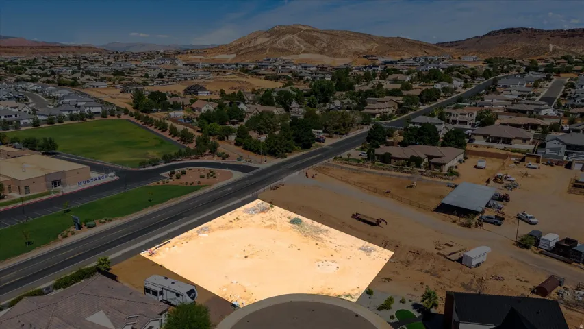 Expansive developable lot with a clear building envelope, surrounded by established residential properties and natural desert terrain
