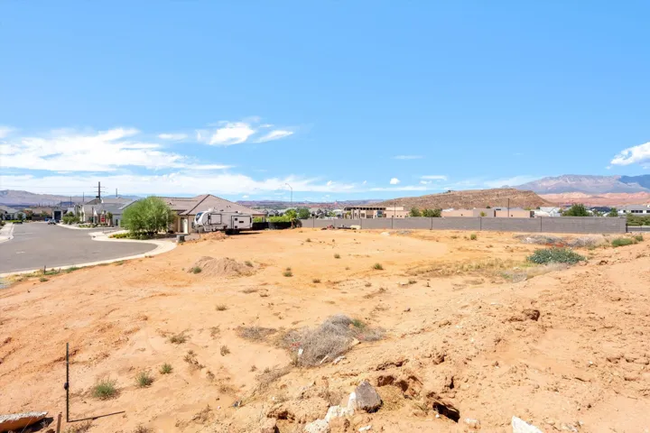 Expansive undeveloped parcel featuring a level building area and a perimeter wall