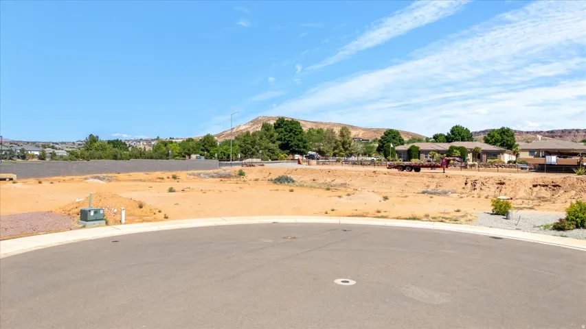 Expansive building site featuring graded terrain and existing utility access