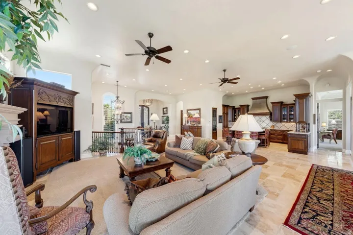 Open concept living area featuring recessed lighting, ceiling fans, and high ceilings