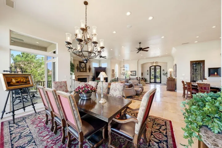 Expansive open-concept living area featuring a formal dining space, recessed lighting, and a large balcony