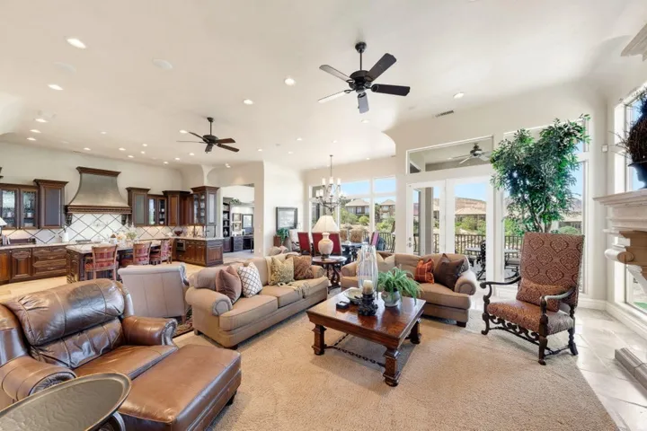Spacious great room with high ceilings, recessed lighting, and large windows