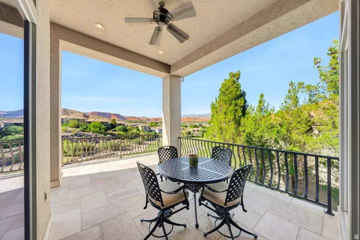 Covered balcony with recessed lighting, ceiling fan, and tile flooring