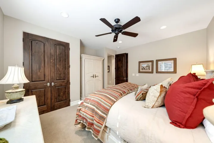 Recessed lighting, ceiling fan with dark wood-finish blades, light-toned wall paint, and carpeted flooring