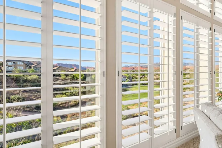 White plantation shutters, multiple window panes, and extensive natural light