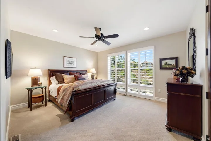 Recessed lighting, ceiling fan, and carpeted flooring