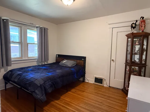 Hardwood flooring, white wall paint, two-pane window, white trim, ceiling-mounted light fixture