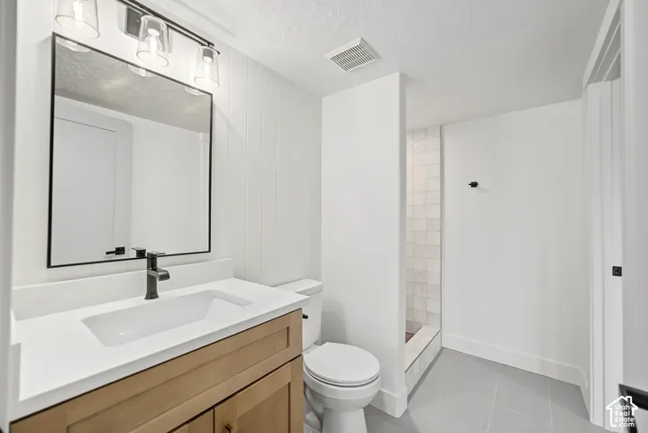 Light wood-finish vanity with white countertop and integrated sink