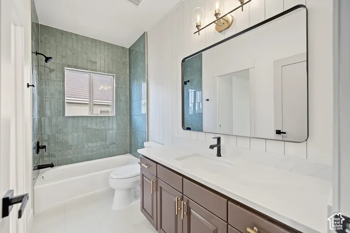 White flat panel vanity with gold-tone hardware, white countertop, and matte black faucet