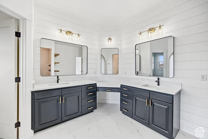 Dual vanities with dark cabinetry and gold-tone hardware