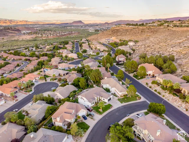 Residential neighborhood with winding streets, mature landscaping, and varied architectural styles