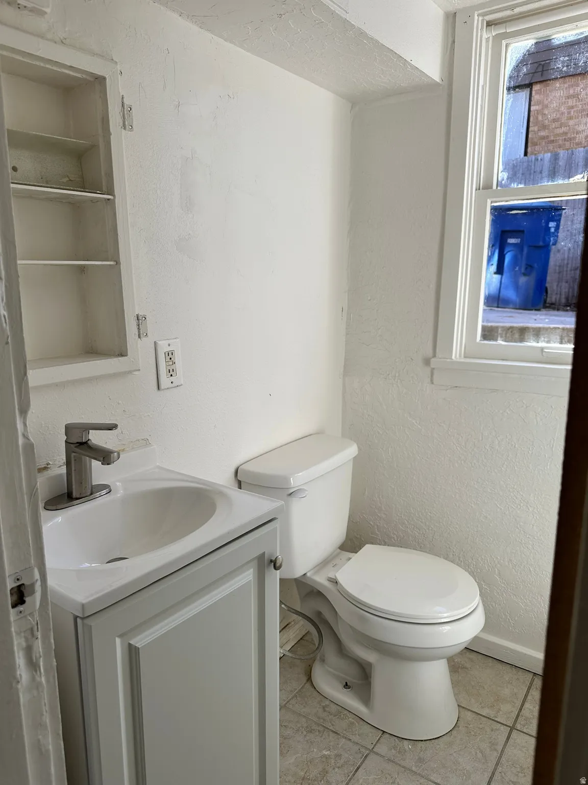 White vanity with integrated sink and chrome faucet