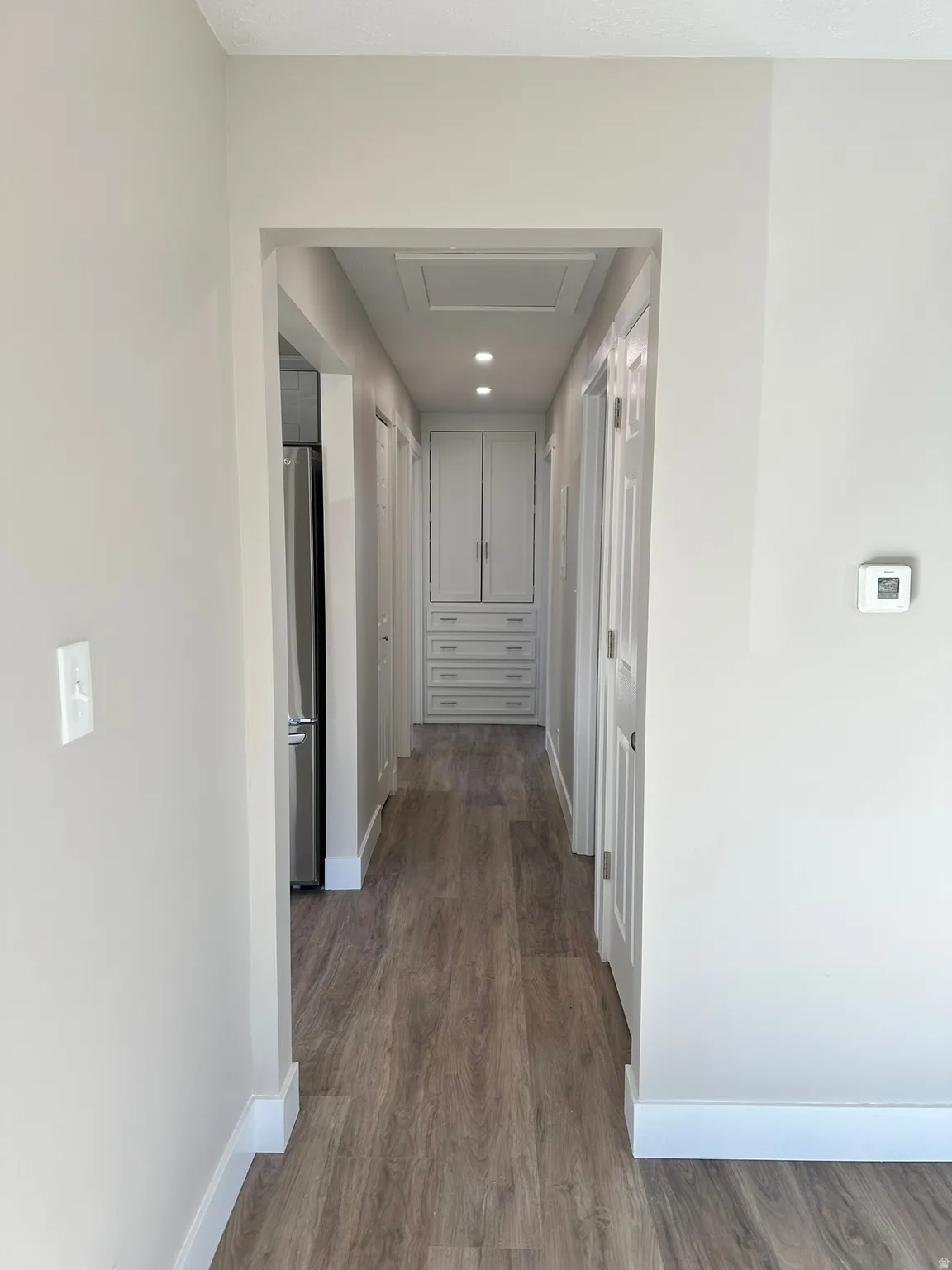 Wood-finish flooring throughout the hallway and added storage drawers and cabinets.