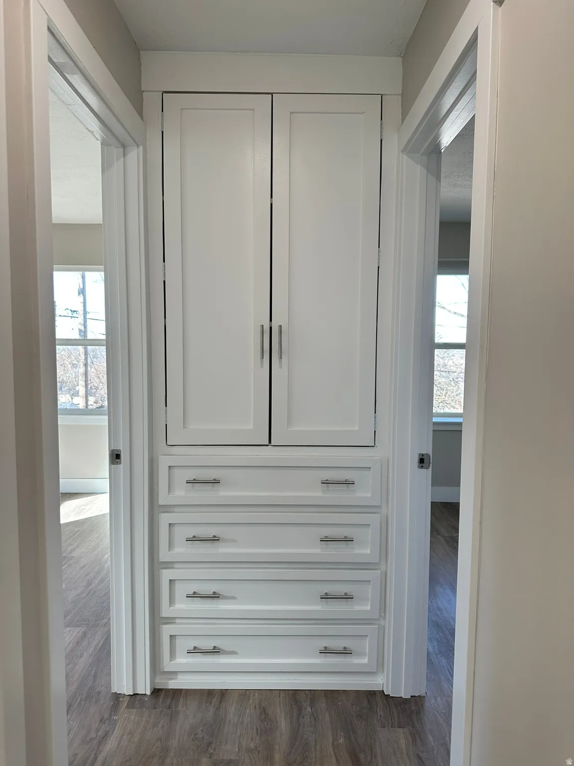 Built-in cabinetry with shaker-style doors and multiple drawers featuring brushed nickel hardware