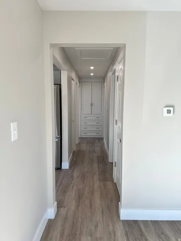 Wood-finish flooring throughout the hallway and added storage drawers and cabinets.