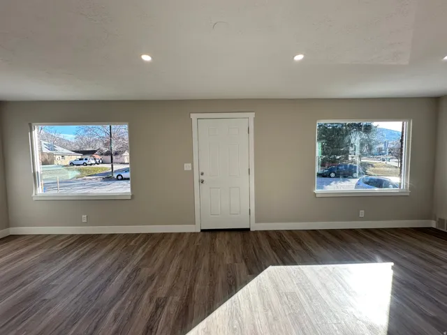 Wood-finish flooring throughout, complemented by recessed lighting and neutral wall tones