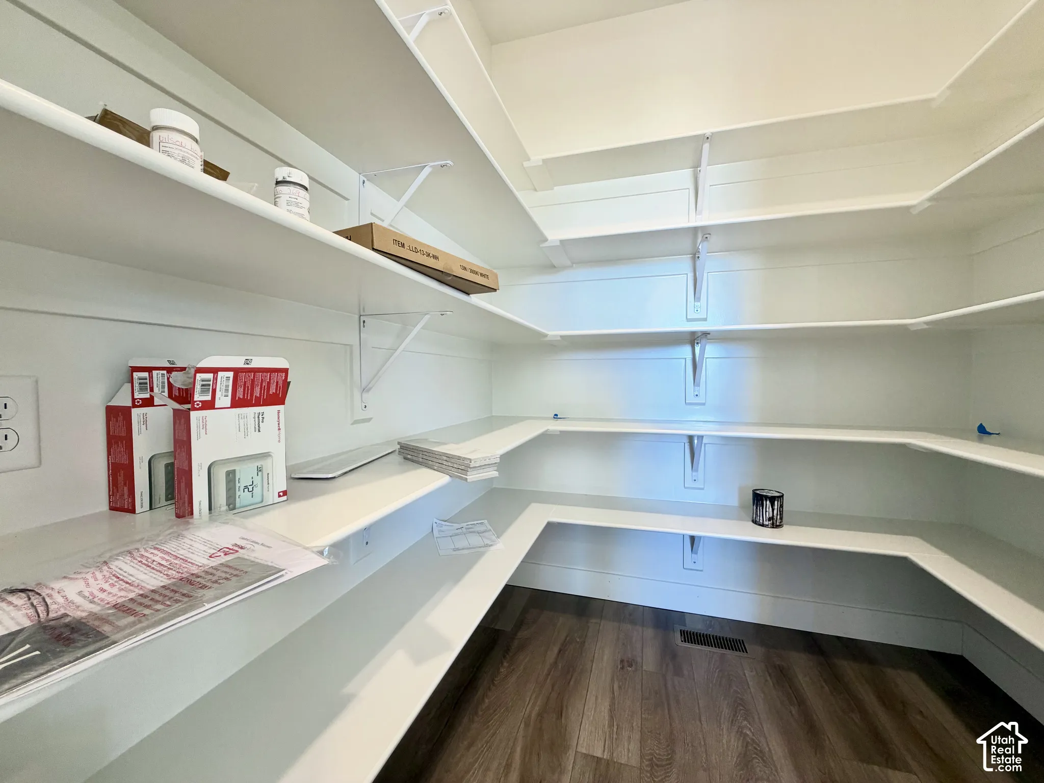 Built-in shelving with white finishes and wood-finish flooring