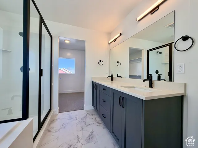 Dual vanity with integrated sinks, light-toned countertops, and matte black fixtures