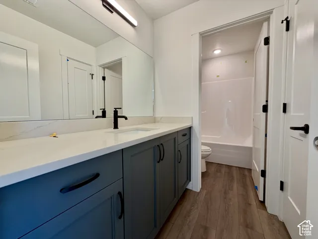 Modern bathroom featuring a vanity with a white countertop, undermount sink, and matte black faucet