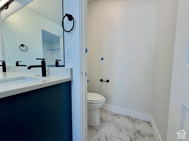 Dual vanity with integrated sinks, matte black fixtures, and a dark-toned cabinet