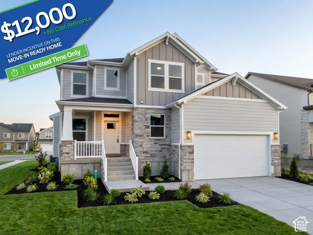 Exterior featuring mixed siding, stone veneer accents, covered front porch with white railing, and a two-car garage