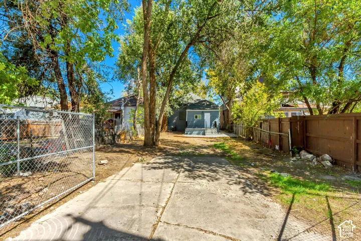 Concrete driveway leading to a rear structure