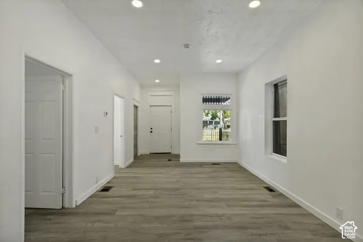 Wood-finish flooring throughout, complemented by white walls