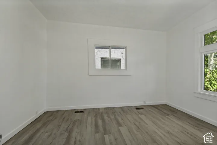 Wood-finish flooring with white walls and trim