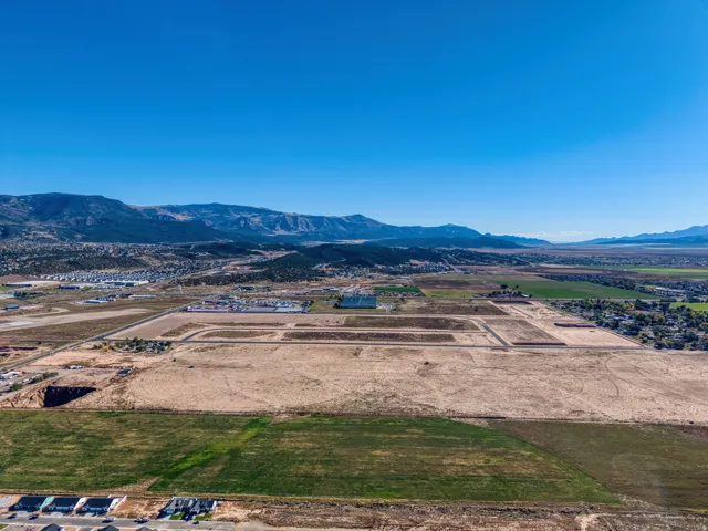 Expansive land offering development potential, surrounded by distant mountains