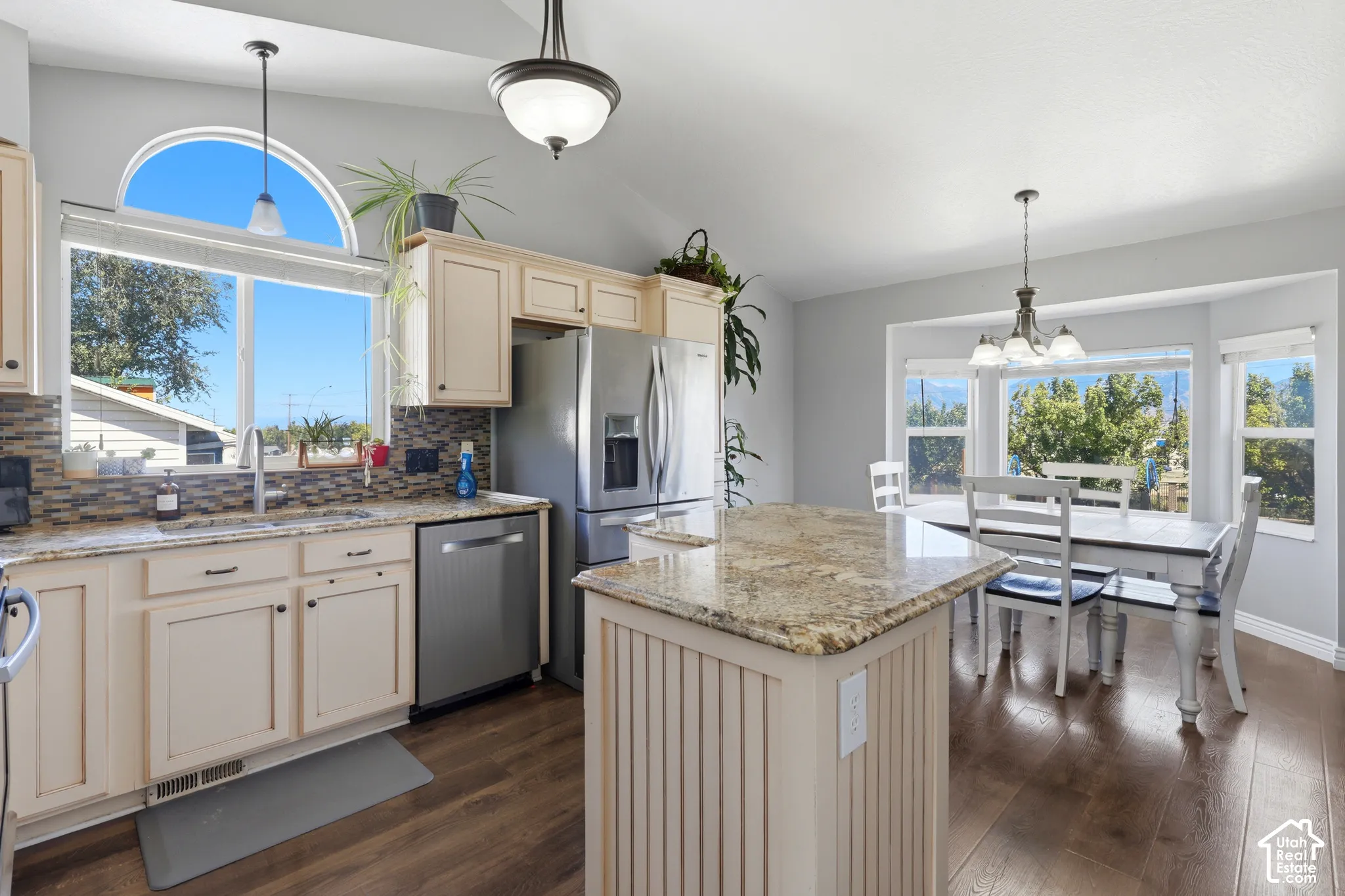 Kitchen featuring wood-finish flooring, light-toned cabinetry, granite countertops, and stainless steel appliances